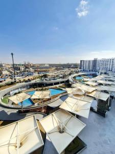 a group of umbrellas on the roof of a building at Axxodia- Duplex Porto New Cairo in Cairo