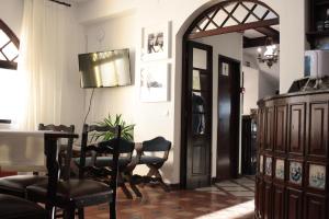 a dining room with a table and chairs and a door at Hotel Ribamar in Nazaré