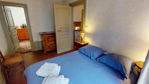 a bedroom with a blue bed with two towels on it at Les appartements hyper centre Barr in Barr