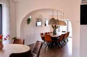 a dining room with a table and chairs at Group Accommodation De Stoep in Appeltern