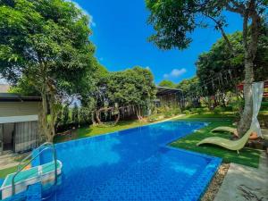 a swimming pool with a slide in a yard at Kayla Homestay - Villa Long An in Ba Vì