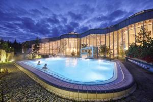 a large swimming pool in front of a building at Haus ZUR PINGE in Kurort Altenberg