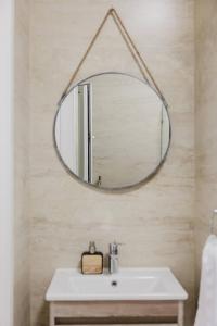 a bathroom with a mirror and a sink at Mellieha 1bed With Outside Terrace By Homely! in Ix-Xagħra taʼ Barra