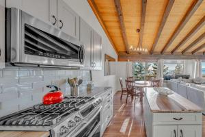 a kitchen with a stove with a red kettle on it at Lake Tahoe Vacation Rental Fireplace and Balcony in Incline Village