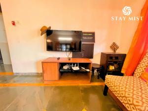 a living room with a tv and a couch at Sea Olive Villa - Stay Mist in Nagaon
