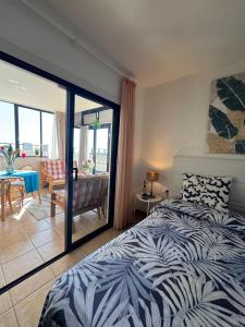 a bedroom with a bed and a view of a balcony at VILLA SISSI Atlantic View in Costa Del Silencio +32 photos
