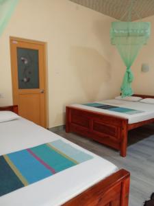 Katil atau katil-katil dalam bilik di Udesh Guest