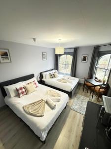 a hotel room with two beds and a table at The Wolfs Tavern in London +108 photos