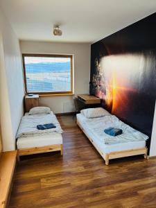 En eller flere senge i et værelse på Holiday House Brezno