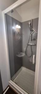 a shower with a glass door in a bathroom at Le Clos du Vieux Porche in La Couarde-sur-Mer