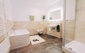 a bathroom with a sink and a toilet and a shower at Waterfront Riverside Premium Suites by ORY Living in Hamburg