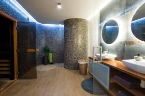 a bathroom with a sink and a toilet and a shower at Wellness apartmán in Ždaňa