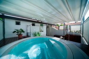 a jacuzzi tub on a balcony with at Hotel Erika in Rimini