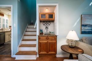 a living room with a staircase and a table at 546 Tarpon Pond Cottage in Seabrook Island