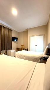 Postel nebo postele na pokoji v ubytování HOTEL DEL REY CURITIBA by POTY - NA FAMOSA RUA XV DE NOVEMBRO