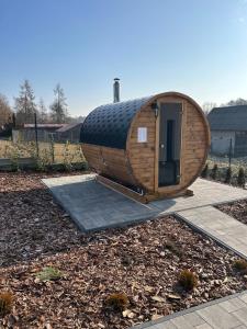 a large wooden hobbit house sitting in a yard at Osada Chańcza in Chańcza