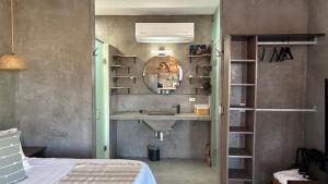a bathroom with a sink and a mirror at Private Jacuzzi Suite Steps to the Beach in La Ventana