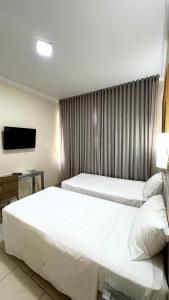 Postel nebo postele na pokoji v ubytování HOTEL DEL REY CURITIBA by POTY - NA FAMOSA RUA XV DE NOVEMBRO