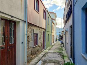 an alley with colorful buildings and a red door at Style in a pedestrian quarter in the city's heart in Porto