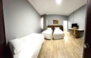 Postel nebo postele na pokoji v ubytování HOTEL DEL REY CURITIBA by POTY - NA FAMOSA RUA XV DE NOVEMBRO