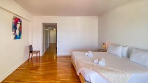 a bedroom with a large white bed and a chair at Que sonho! Vista Marina T2 HsR Vilamarina in Vilamoura +19 photos