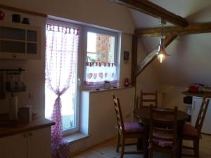 a kitchen with a table and a large window at Auszeit Landleben in Sallgast