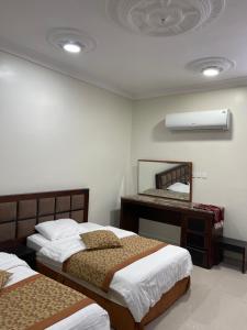 Ένα ή περισσότερα κρεβάτια σε δωμάτιο στο شقق زد السكنية