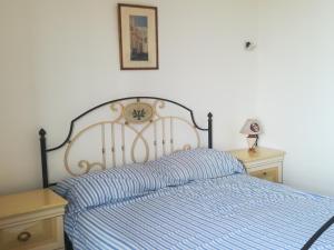 a bedroom with a bed with a clock on it at Italy, Calabria, PIZZO rent apartment 2 room in Pizzo