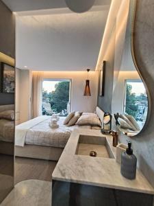 a bedroom with a large bed and a sink at L'écrin d'Azur appartement 5 personnes à 5 minutes à pied de la mer in Saint-Raphaël