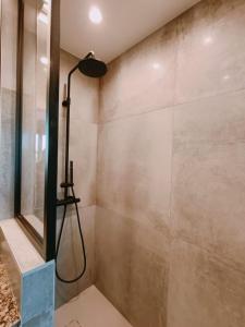 a bathroom with a shower with a shower head at L'écrin d'Azur appartement 5 personnes à 5 minutes à pied de la mer in Saint-Raphaël +12 photos
