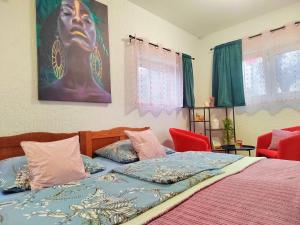 a bedroom with a bed with a painting on the wall at Apartman Jezz II, Zagreb in Zagreb