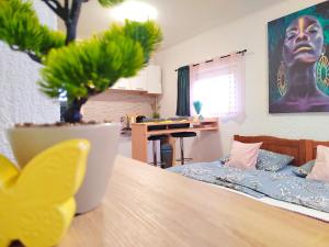a room with a table with a potted plant on it at Apartman Jezz II, Zagreb in Zagreb