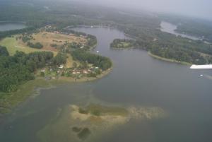 an aerial view of a group of islands in a lake at Ferienwohnungen Charlottenhof in Zechlinerhütte