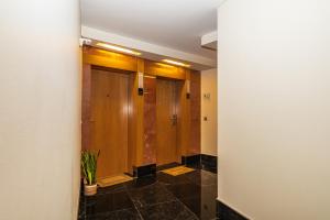 a hallway with wooden doors and a potted plant at Forum Ocean View 5B by Homie in Ilhéu do Gorgulho