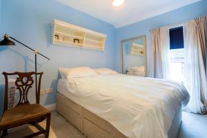 a blue bedroom with a bed and a chair at 3-Bed House in Dublin City Centre in Dublin