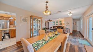 a dining room and kitchen with a table and chairs at Tee Time on Breezemont in Sarasota