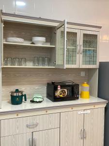 a microwave sitting on a counter in a kitchen at Escadia Homestay in Bandar Penawar in Bandar Penawar