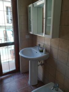 a bathroom with a sink and a mirror and a toilet at Italy, Calabria, PIZZO rent apartment 2 room in Pizzo