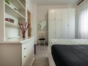 a bedroom with a bed and a dresser and shelves at Casa Zirocco in Sperlonga