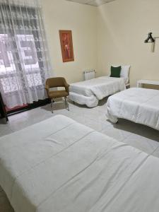 Postel nebo postele na pokoji v ubytování Hostal Real