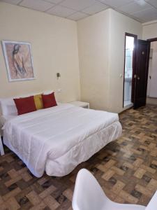 Postel nebo postele na pokoji v ubytování Hostal Real