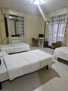 Postel nebo postele na pokoji v ubytování Hostal Real