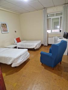 Postel nebo postele na pokoji v ubytování Hostal Real
