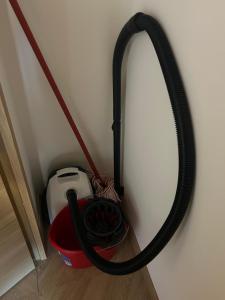 a hose is hanging on a wall next to a toaster at Studio 50m des pistes in La Salle-les-Alpes