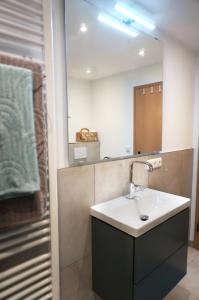 a bathroom with a sink and a mirror at BERG & WALD Ferienwohnungen in Schönau am Königssee +35 photos