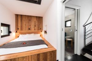 a bedroom with a large bed with a wooden headboard at Luxury Holiday Home Itana with Private Pool and Sea View in Dragove +51 photos