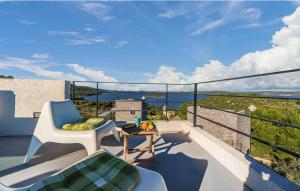 a balcony with a chair and a table and a view at Luxury Holiday Home Itana with Private Pool and Sea View in Dragove