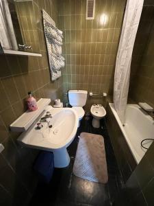 a bathroom with a sink and a toilet and a tub at Dupléx en Estación de Manzaneda in Prada +14 photos