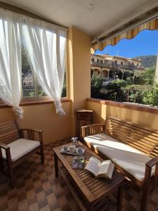 a living room with two beds and a table with books at Casa Naldina in Marciana Marina