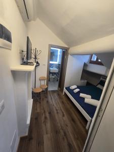 a small room with a bed and a desk at Grazioso Room in Milan